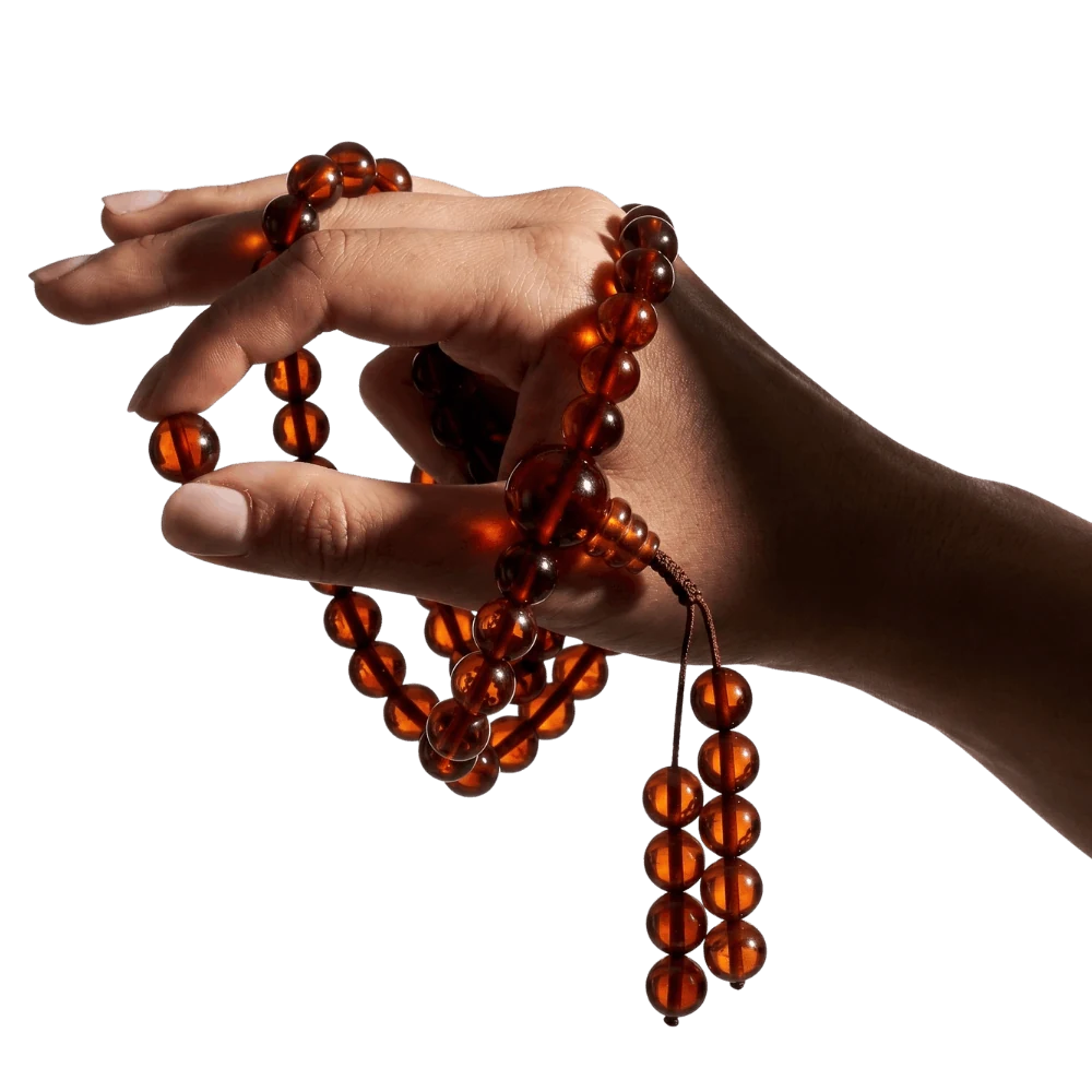 Hand holding a Baltic amber mala